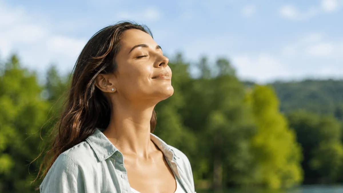 Woman enjoying fresh outdoor air during good AQI conditions explained in Filterbuy's air quality ranges guide.
