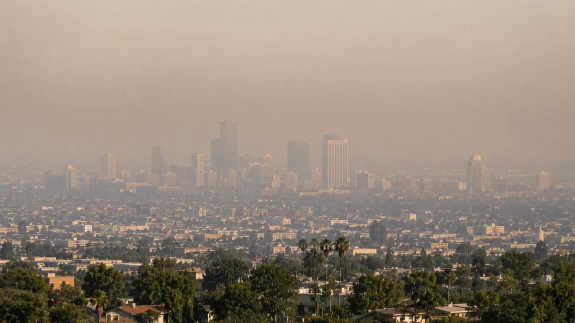 City skyline covered by wildfire smoke and haze, showing why air quality is bad today in many regions.
