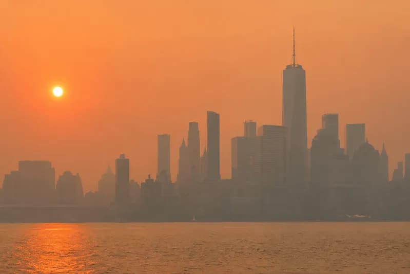 Canadian wildfire smoke reducing visibility and air quality across a U.S. city skyline