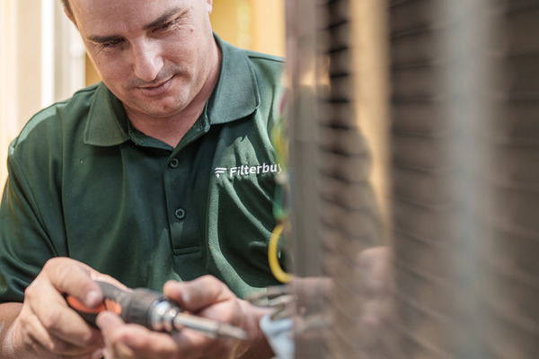 Best HVAC installation services company in Palmetto Bay FL - A picture of Filterbuy HVAC technician doing an HVAC installation service in Palmetto Bay FL